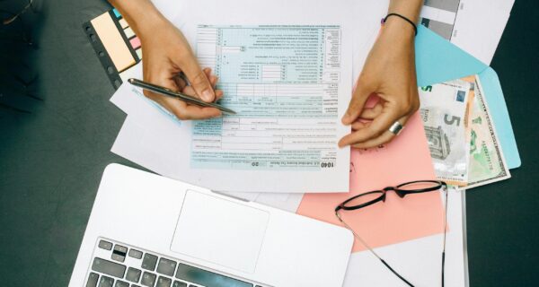Income-Tax-2 Oakland Bay Area homeowner reviewing real estate investment and capital gains information